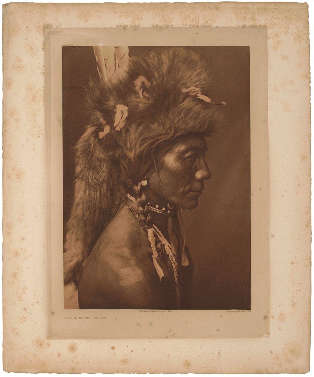 This Edward Curtis photogravure had severe reverse mat burn and foxing.